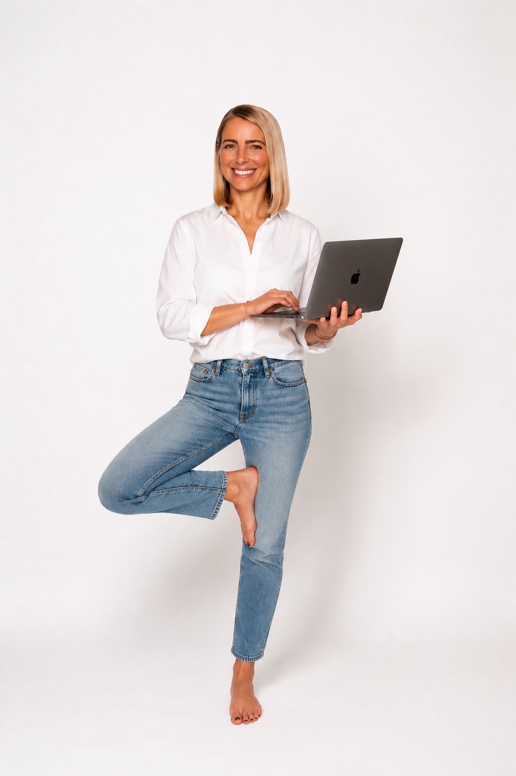 Britt, founder of The BDR Collective, standing with a laptop
